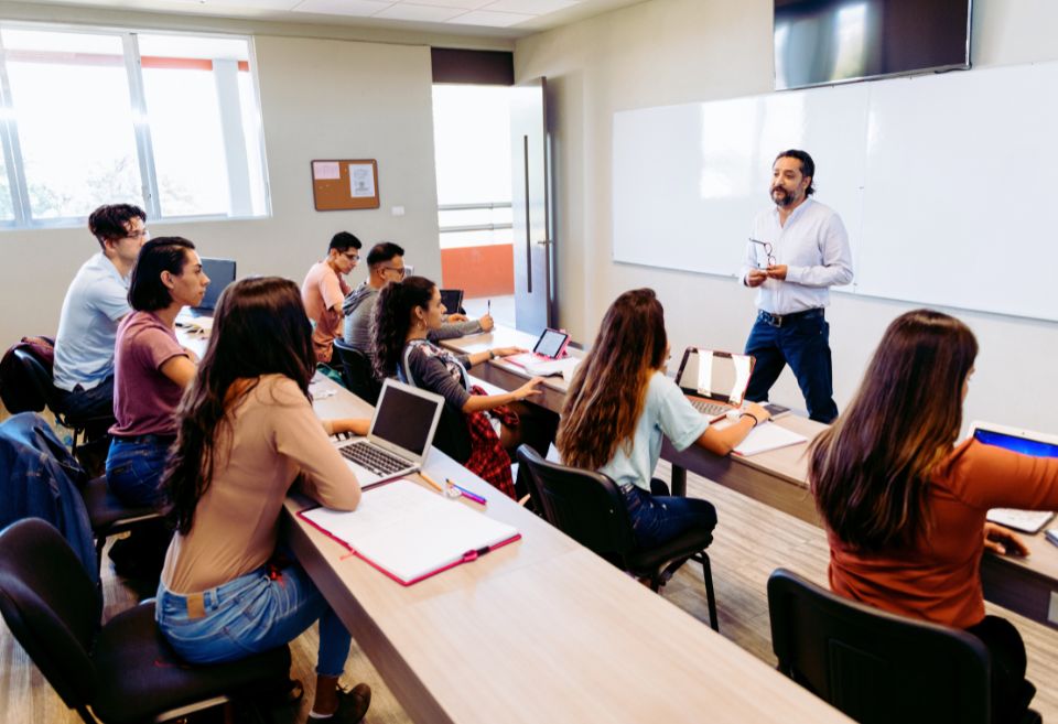 Professeur en salle de classe universitaire, illustrant l'importance du financement adéquat pour la recherche au Québec et au Canada, notamment dans le contexte des débats sur l'inégalité des ressources financières entre les universités canadiennes.